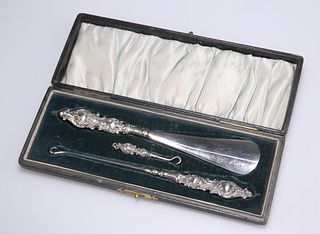 AN EDWARDIAN SILVER-HANDLED BUTTON, GLOVE AND SHOE SET, by 
