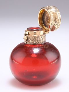 A VICTORIAN GOLD-MOUNTED RUBY GLASS SCENT BOTTLE, the spher