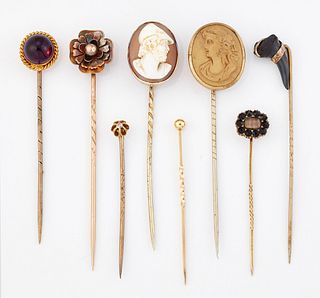 A GROUP OF EIGHT STICK PINS, including; A FOSSILISED TOOTH 