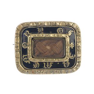 A mourning brooch. Designed as a rectangular glazed panel with woven hair to the centre, to the blac