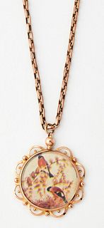A GLAZED LOCKET PENDANT ON CHAIN, a circular pendant within