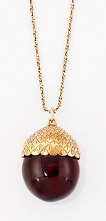 AN AMBER ACORN PENDANT ON CHAIN, an amber 'acorn' held with
