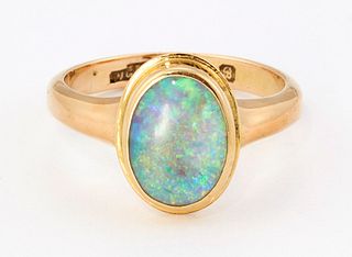 AN 18CT GOLD OPAL RING, an oval opal in a bezel setting, to
