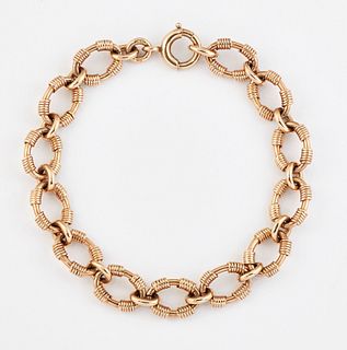 A 9CT GOLD BRACELET, of oval links with coiled decoration, 