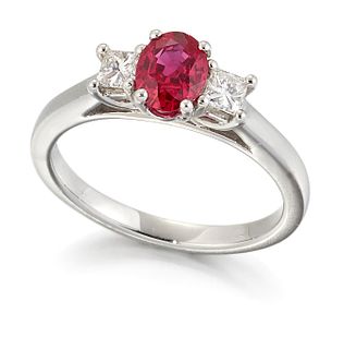 A PLATINUM RUBY AND DIAMOND THREE STONE RING, an oval-cut r