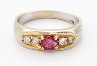 A RUBY AND DIAMOND RING, an oval-cut ruby between pairs of 