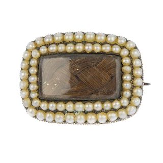 A Victorian brooch and stickpin. To include a late 19th century gold split pearl memorial brooch wit