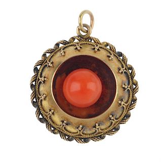 A late 19th century gold coral set pendant. Of circular outline, the central spherical coral bead wi
