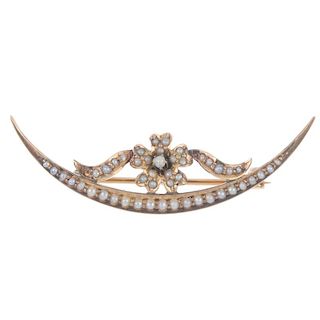 An early 20th century gold split pearl brooch. Designed as a crescent shape with flower shape to the