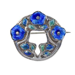 MURRLE BENNETT - a silver enamel brooch. Of circular outline with blue enamel flower and green/blue
