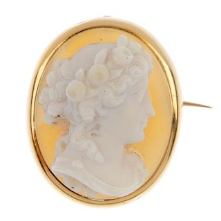 A hardstone cameo brooch. The hardstone carved in relief to depict a lady with roses in her hair, to