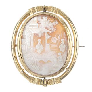 A late 19th century rolled gold swivel cameo brooch. Of oval outline, the shell cameo carved to depi