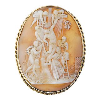 A cameo brooch. Of oval outline, the shell cameo carved to depict Christ's crucifixion, to the rope-