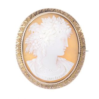 A cameo brooch. Depicting Dionysus, god of grape harvest, winemaking and wine, with grapes and vine