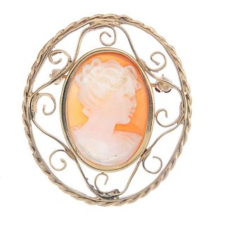 A cameo brooch. The oval cameo a typical profile of a lady, to the open scrollwork surround. Length