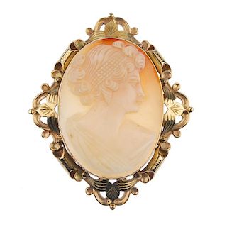 A gold shell cameo brooch and a pair of gold ear studs. The brooch designed as an oval outline to th