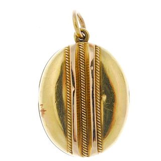 A late 19th century gold locket. Of oval outline, the embossed rope-twist and raised line detail, to