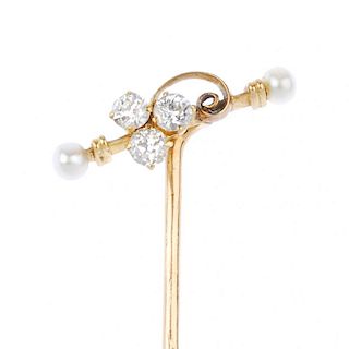 A seed pearl and diamond stickpin. The old-cut diamond trefoil, to the scrolling highlight and seed