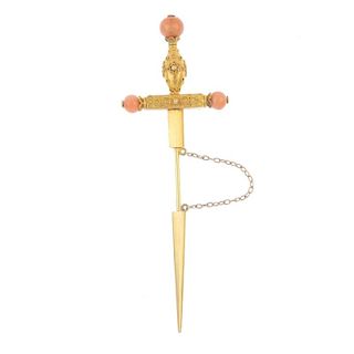 A late 19th century gold coral set stickpin. Designed as a sword with cannetille detail to the hilt