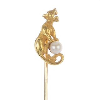 A seed pearl novelty stickpin. Modelled as a textured tiger, mounting a seed pearl. Length of stickp