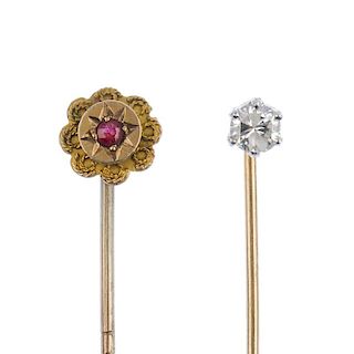 Two stickpins. The first designed a single brilliant-cut diamond stickpin, the second of floral outl