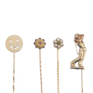 Four stickpins. To include two early 20th century gold gem-set floral stickpins, together with a gol