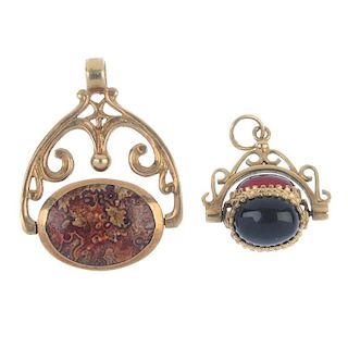 Two 9ct gold gem-set swivel fobs. The first of oval design inlaid with agate, the second set with th