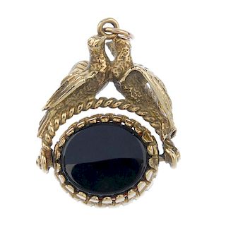 A 9ct gold swivel fob. The swivel fob set with carnelian and onyx, to the twin bird pedestal. Hallma