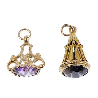 Two 9ct gold gem-set fobs. The first designed as an oval-shape amethyst to the scrolling 9ct gold gr