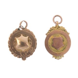 Two early 20th century 9ct gold medallions. Of circular outline with scrolling detail, one with pers