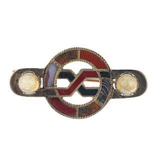 A late 19th century gold agate brooch. The central open circle to the interwoven stylised figure of