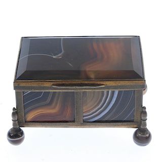 An agate trinket box. The brass framed box with agate panels, lid and spherical agate feet. Length 6