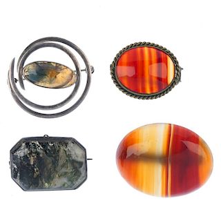 A selection of agate brooches. To include a Malcolm Gray brooch, the curved border to the central ov