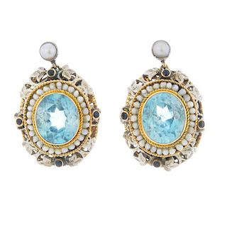 A pair of zircon and seed pearl cluster ear pendants. Each designed as an oval-shape blue zircon and