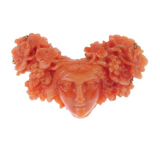<p>A mid 19th century carved coral bacchante brooch. Depicting the head of a bacchante or Maenad, a