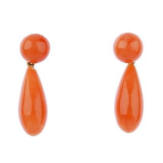 A pair of coral ear pendants. Each designed as a coral drop, suspended from a coral bead surmount. C