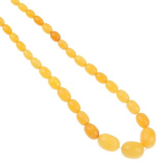 A natural amber necklace. Comprising forty-two graduated, oval-shape beads measuring 2.1 to 1.1cms,