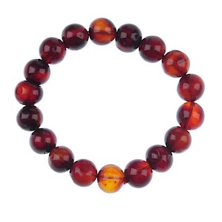 A natural Burmese blood amber bracelet. Comprising eighteen spherical beads measuring 11mm, strung t