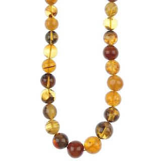A natural Burmese milky amber necklace. Comprising 110 graduated spherical beads measuring 0.6 to 1.