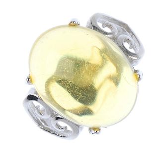A natural Burmese high blue amber ring. The cabochon of pale yellow colour, measuring 1.6cms. Ring s