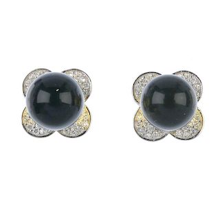 A pair of natural Burmese high blue amber ear studs. The spherical amber, measuring 0.9cms, to the f