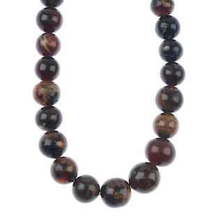 A natural Burmese root amber necklace. Comprising sixty-two spherical Burmese root amber beads measu