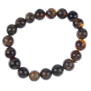 A natural Burmese root amber bracelet. Comprising nineteen spherical beads, each measuring approxima