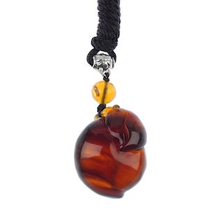 A natural Burmese milky amber carved pendant. The single piece of amber, carved into the form of a f