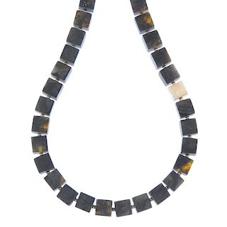 Ten amber necklaces and two matching bracelets of cube link design. The necklace each comprising for