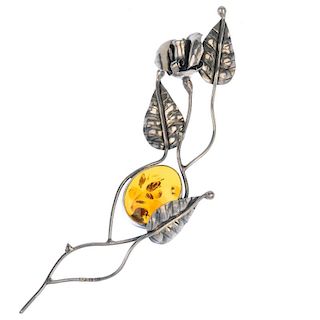 A modified amber necklace and brooch. The necklace consisting of twenty-seven free-form modified amb