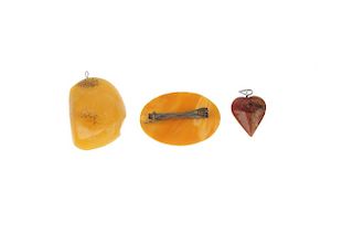 A selection of natural and modified amber jewellery. To include a natural amber brooch of oval outli
