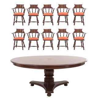 Comedor. SXX. Elaborado en madera. Consta de mesa y 10 sillones. Mesa con cubierta circular, fuste a manera de jarrón.