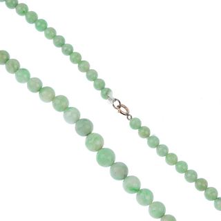 A jade necklace and two bangles. The necklace comprising graduated spherical beads, to a spring-ring