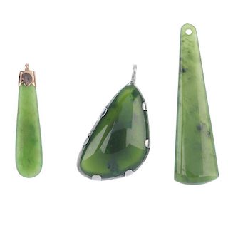 Three nephrite jade pendants. To include a late 19th century gold mounted pendant of pear-shape outl